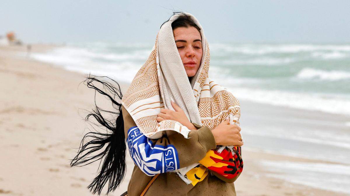 Wynwood neighborhood resident, Bailey Johnson, 24, says she is taking a serene break from the stormy atmosphere, seeking to recharge and find peace on South Beach while visiting Miami Beach, Florida on Friday, December 15, 2023.