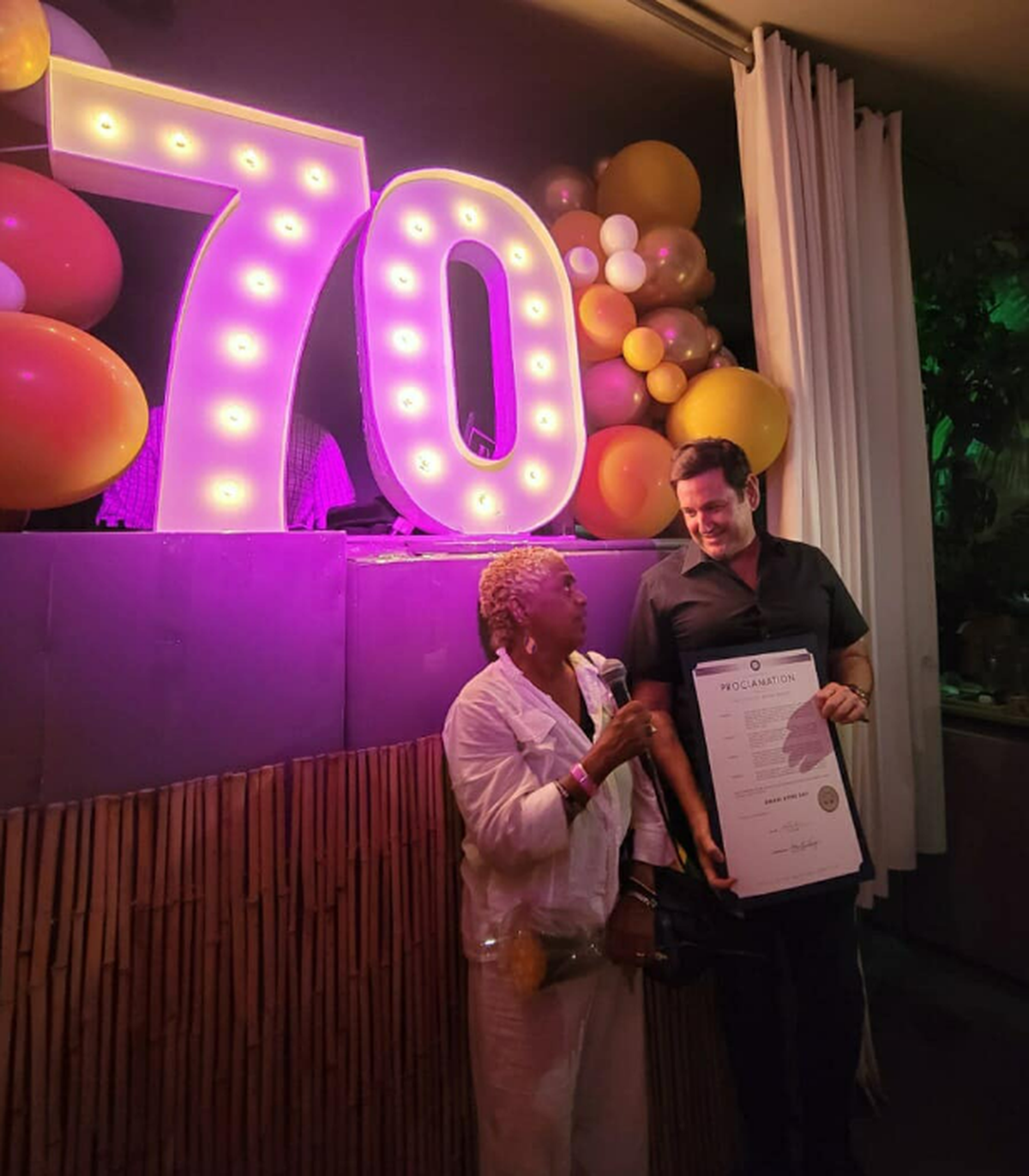 Michael Gongora presents a proclamation on behalf of Commissioner Alex Fernandez at Fat Ronnie’s Burger Bar in Miami Beach in March 2023.