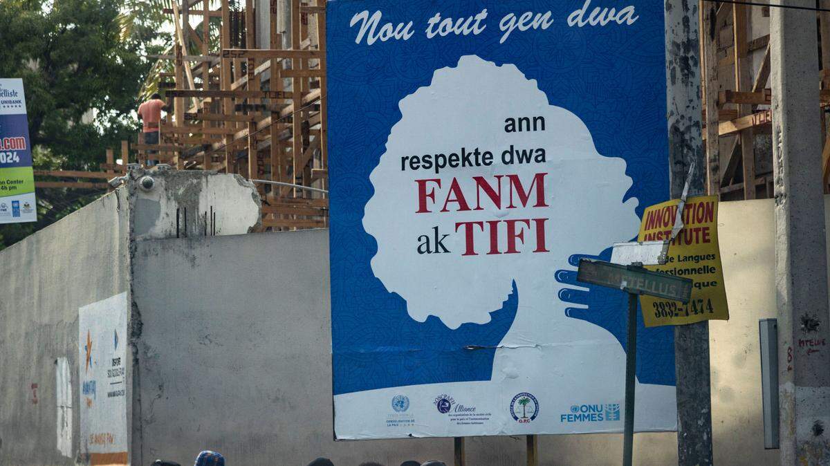 An anti-rape billboard on a street in Pétion-Ville, Haiti, demands that the rights of women and girls be respected.