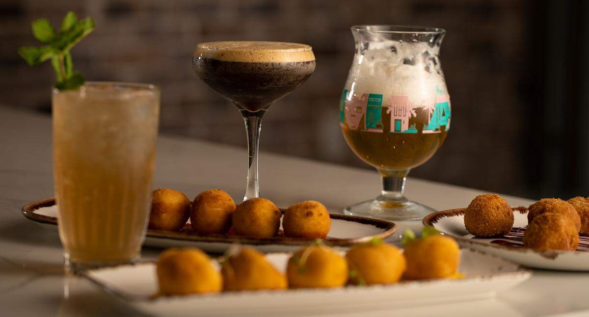 Croquetas with jamon serrano, garlic shrimp and goat cheese are served at Colada Cuban Café in downtown Miami.