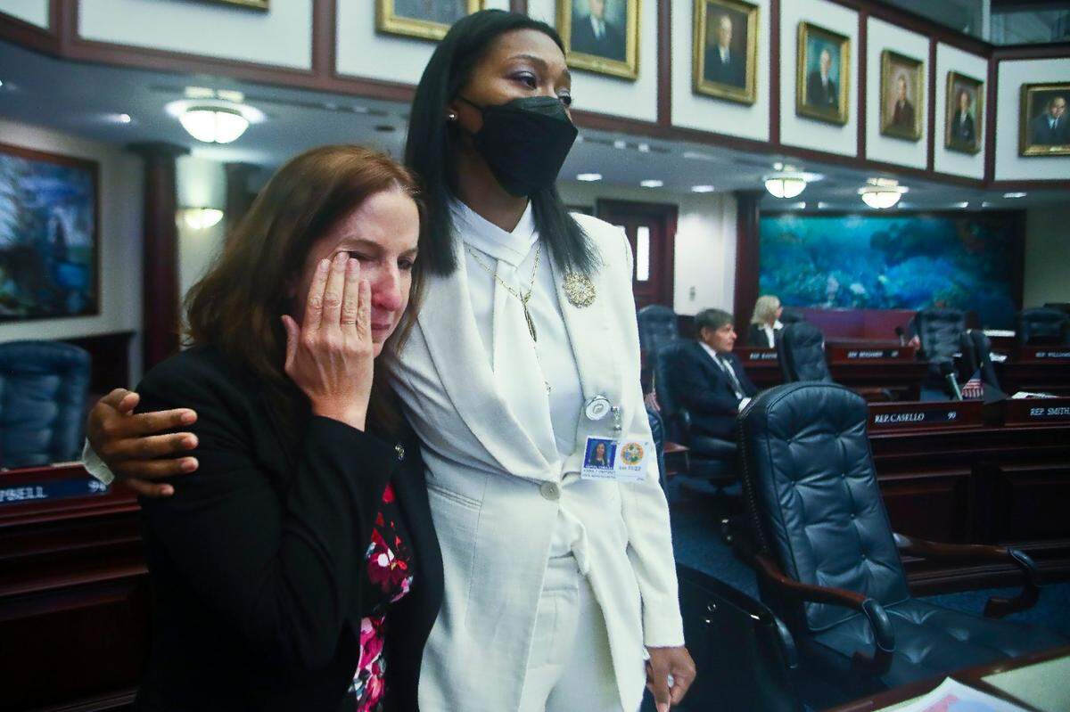 Rep. Robin Bartleman, D-Weston, wipes tears as she is hugged by Rep. Anika Omphroy, D-Lauderdale Lakes, as debate stops for an on-floor protest by Democrats on Senate Bill 2-C: Establishing the Congressional Districts of the State in the House of Representatives, Thursday, April 21, 2022 at the Capitol in Tallahassee, Fla.