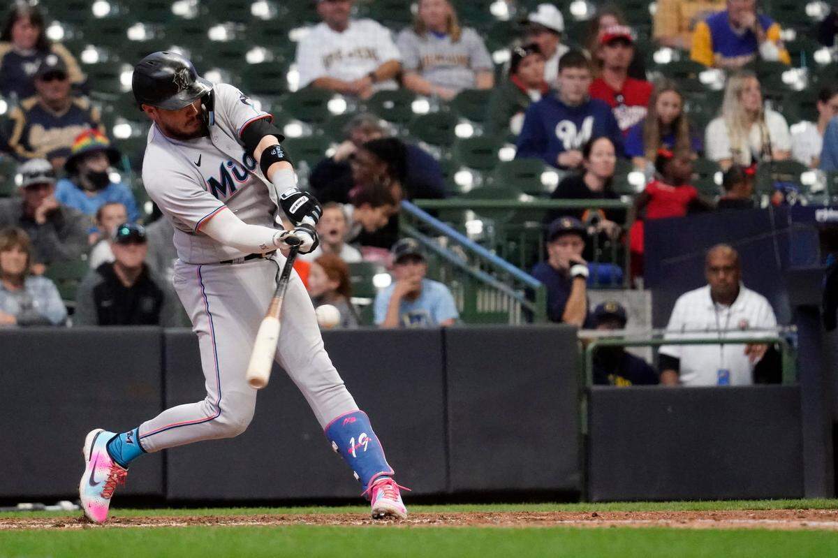Miami Marlins’ Miguel Rojas hits an RBI-single during the 12th inning of a baseball game against the Milwaukee Brewers, Sunday, Oct. 2, 2022, in Milwaukee. (AP Photo/Aaron Gash)