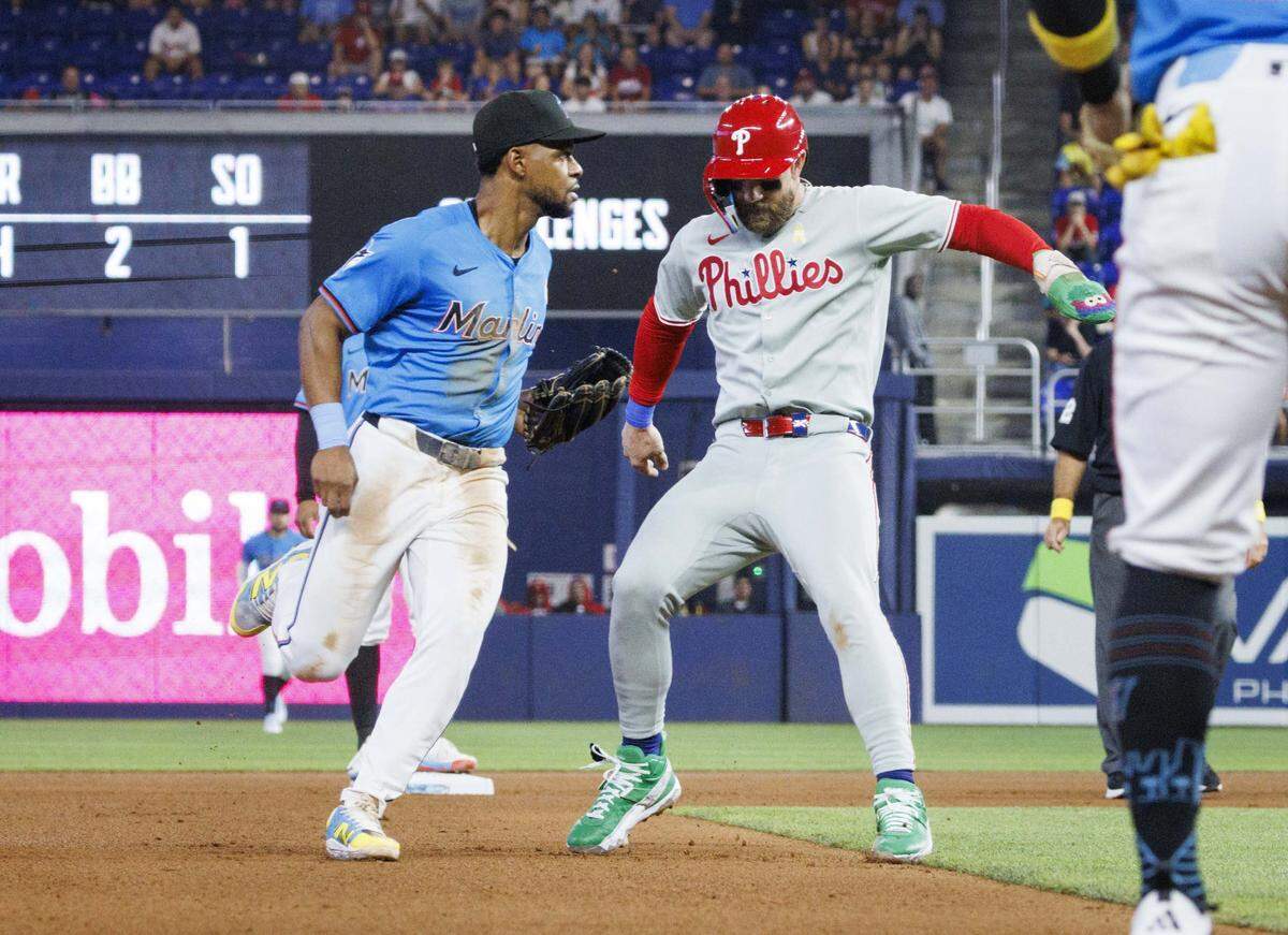 Miami Marlins shortstop Otto Lopez (6) tags Philadelphia Phillies first baseman Bryce Harper (3) out between bases during the fourth inning of a game on Sunday, Sept. 7, 2025, at loanDepot Park in Miami, Fla. 