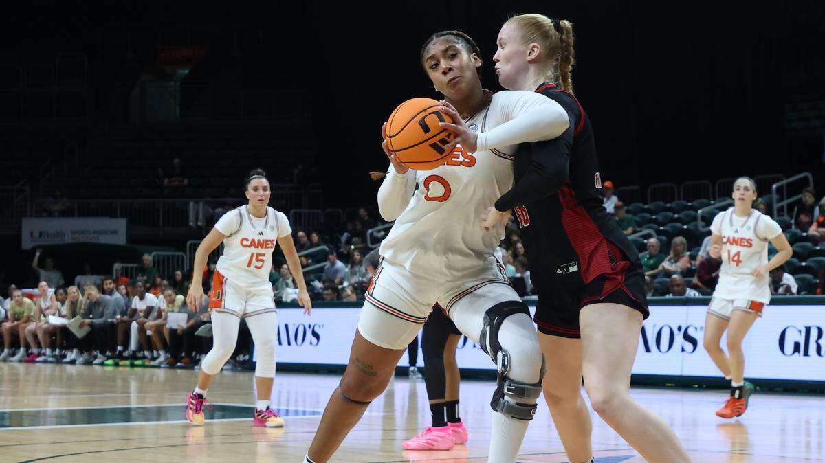 UM center Ra Shaya Kyle, left, drives past NC State forward Tilda Trygger towards the baskets during the first half as University of Miami Women's basketball played in the ACC opener against North Carolina State at the Watsco Center in Coral Gables, Florida, on Sunday, December 14, 2025.
