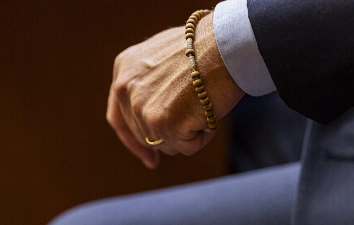 George Pino holds a small cross in his left hand while attending his trial at the Richard E. Gerstein Justice Building on Friday, June 12, 2026, in Miami, Fla. Pino is charged in connection to the boat crash that killed 17-year-old Lucy Fernandez in 2022.