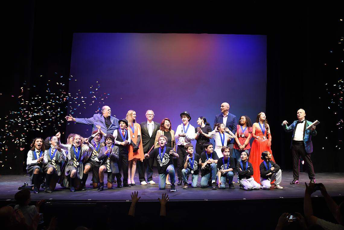 The winners of the 2025 Young Talent Big Dreams finals up front celebrate on stage with judges David Arisco, Howard Cohen and Giselle Deyá. Also in the back row: Actors’ Playhouse’s Barbara Stein (center) and Earl Maulding (far right) and The Children’s Trust’s Felix Beccera.