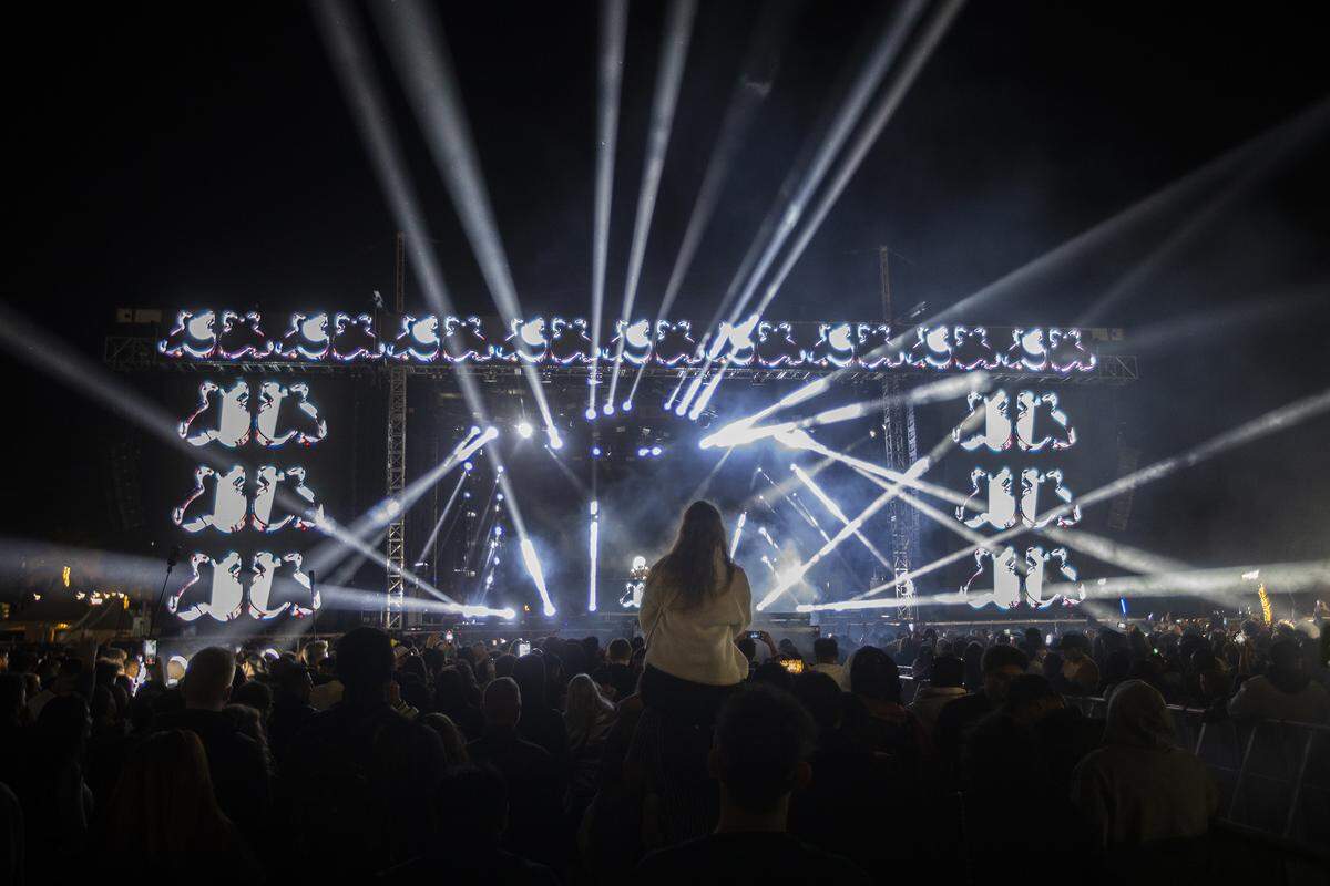 People watch as Marshmello performs during New Year’s Eve celebrations.