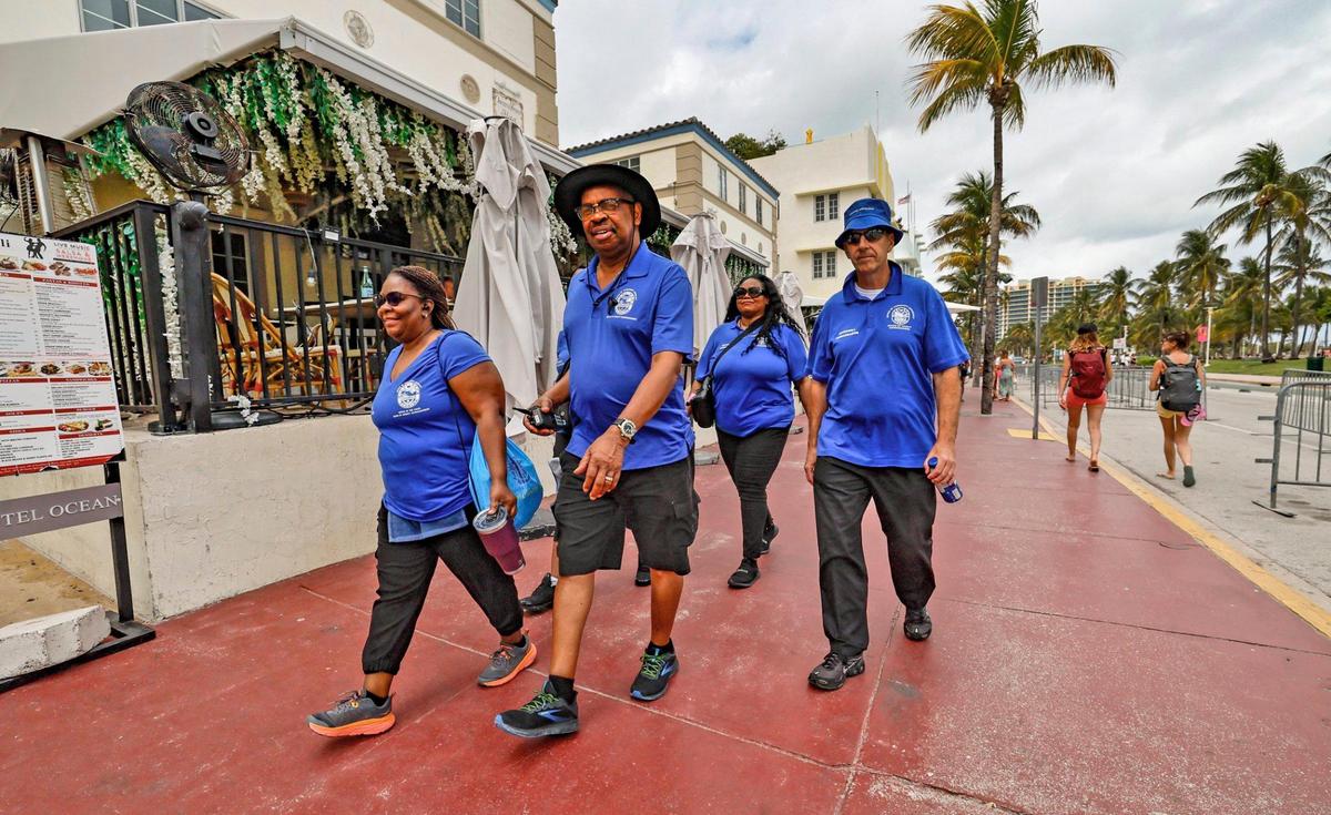 Goodwill Ambassadors with the Miami-Dade County Office of Community Advocacy walk along Ocean Drive during spring break on Miami Beach, Florida on Saturday, March 15, 2025. At left to right are, Teneshia Page, Jeffery Randall, Sheriba Campbell and Denis Hillar.