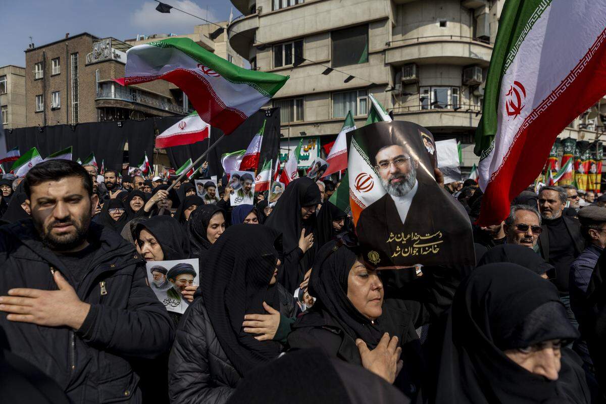 TEHRAN, IRAN - MARCH 11: A woman holds a poster of the new Supreme Leader Mojtaba Khamenei as funerals are held for members of Iran's Revolutionary Guards Corps (IRGC) and other military figures at Enghelab Square on March 11, 2026 in Tehran, Iran. The deceased were killed during the joint U.S.-Israeli strikes in Iran that began on February 28. Iran has retaliated by firing waves of missiles and drones at Israel, and targeting U.S. allies in the region. (Photo by Majid Saeedi/Getty Images)