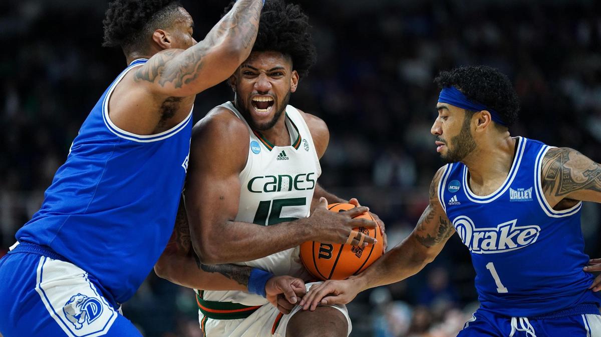 Hurricanes forward Norchad Omier, who had 12 points and 14 rebounds, drives to the basket against Drake Bulldogs forward Darnell Brodie, left.