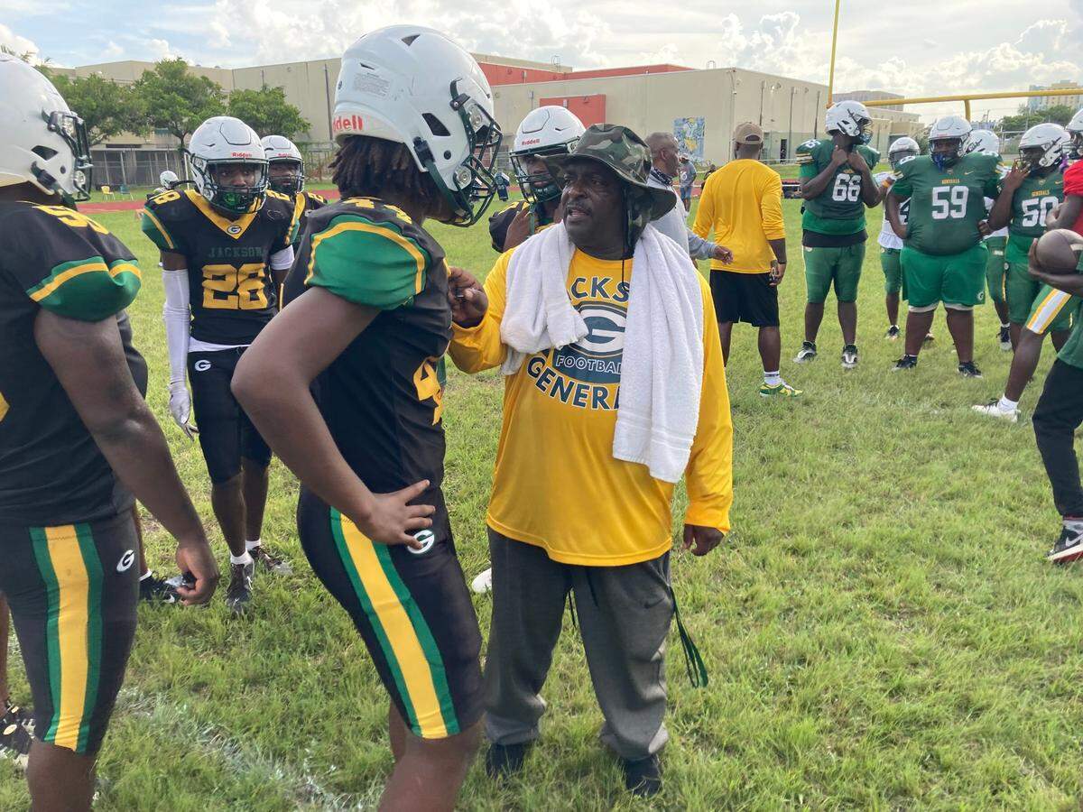 Miami Jackson football coach Max Edwards speaks to one of the Generals’ players during a recent practice at the school.