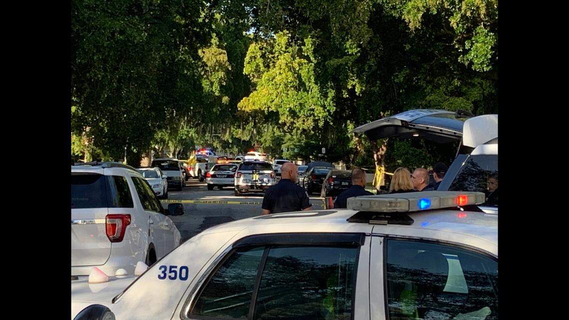 The Sunday morning scene in the 100 block of Calabria after a Coral Gables police officer killed a car burglary suspect. The suspect’s body is under the yellow tarpaulin on the U-Haul truck in the distance.