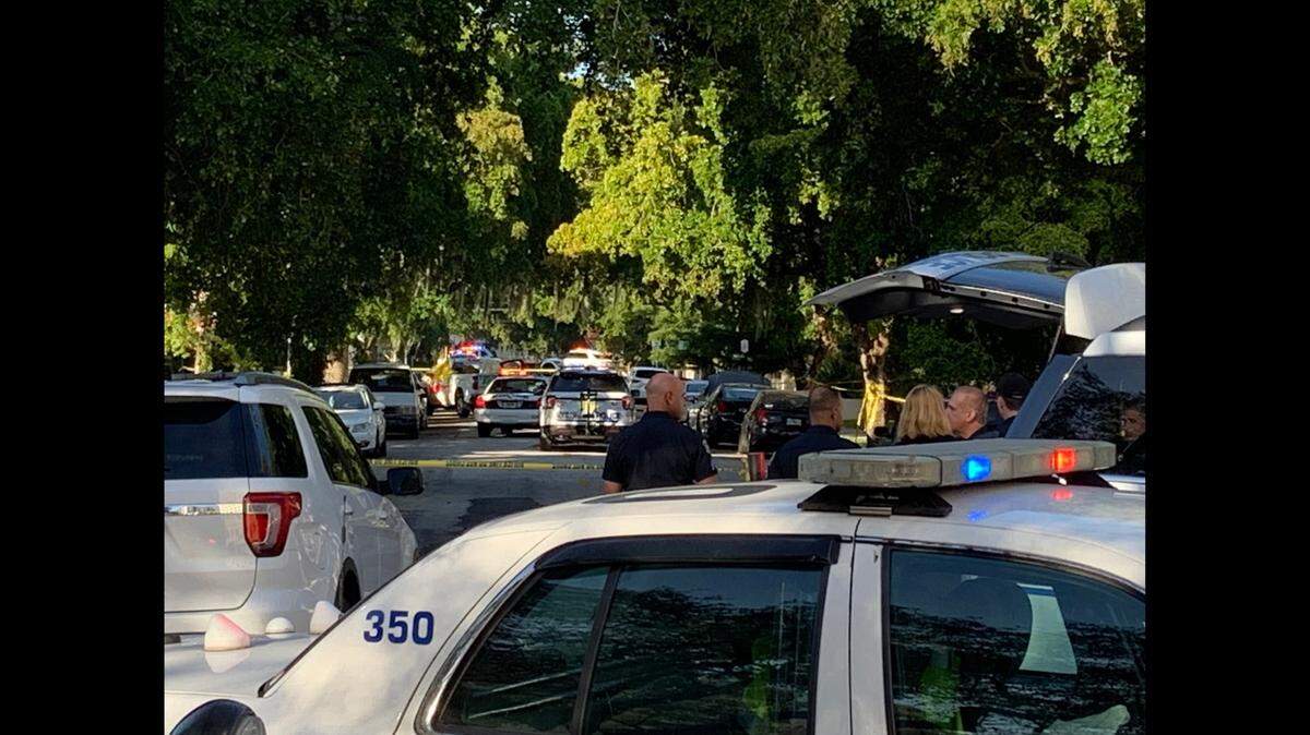 The Sunday morning scene in the 100 block of Calabria after a Coral Gables police officer killed a car burglary suspect. The suspect’s body is under the yellow tarpaulin on the U-Haul truck in the distance.