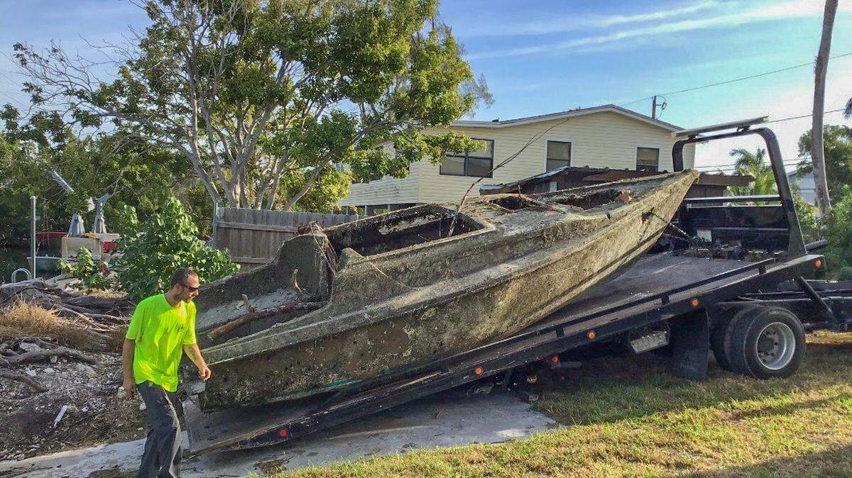 Crews hired by the county to clean up Keys canals remove a sailboat from a canal on Lower Sugarloaf Key.
