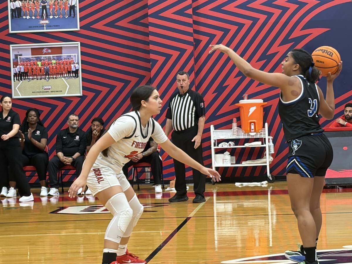 Doral Academy’s Stephanie Vega (left) defends South Dade’s Yarianna Torres (right) during Friday’s Region 4-7A girls’ basketball final at the Doral Academy gym.