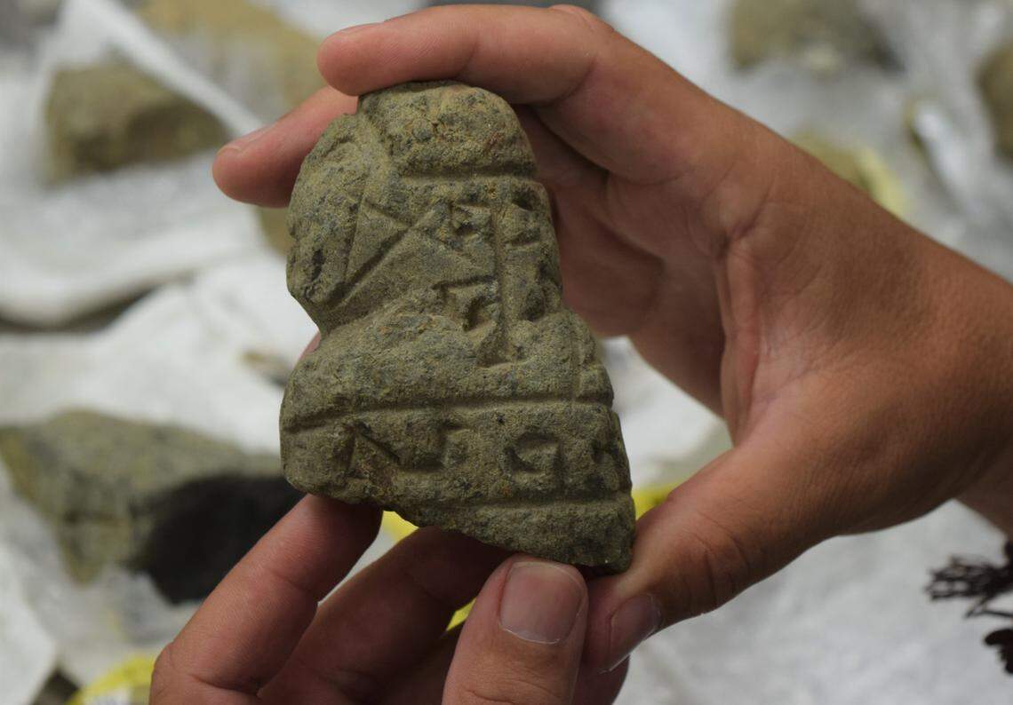 Reniel Rodríguez Ramos, an archaeologist at the University of Puerto Rico’s Utuado Campus, holds one of the “Father Nazario Stones” he’s been studying.