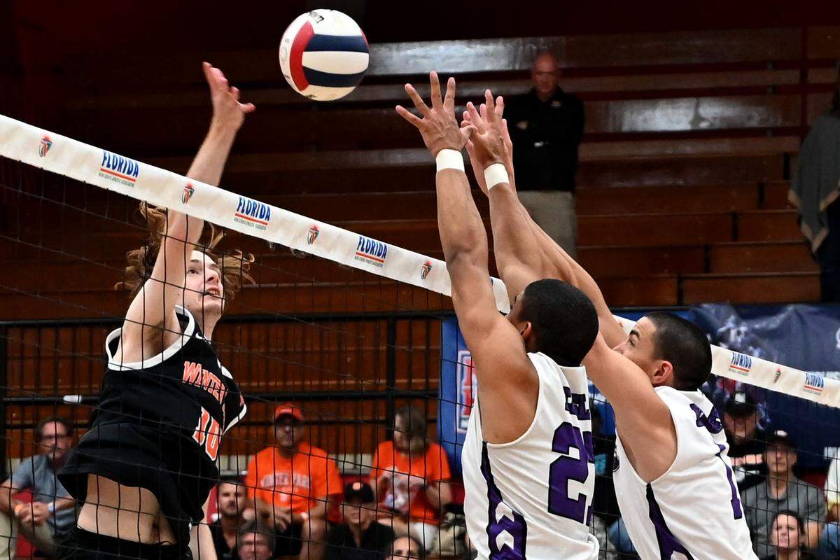 Southwest defenders Marion Albornoz (27) and Kevin Munoz (1) attempt to block a shot from John Williams of Winter Park during the boys volleyball state championship match at the FHSAA Finals on Saturday at Polk State College.