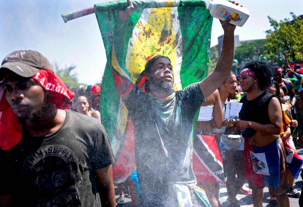 Powder flies in the air over revelers and participants at the the West Indian American Day Parade in the Brooklyn borough of New York, Monday, Sept. 3, 2018. New York’s Caribbean community has held annual Carnival celebrations since the 1920s, first in Harlem and then in Brooklyn, where festivities happen on Labor Day. (AP Photo/Craig Ruttle)
