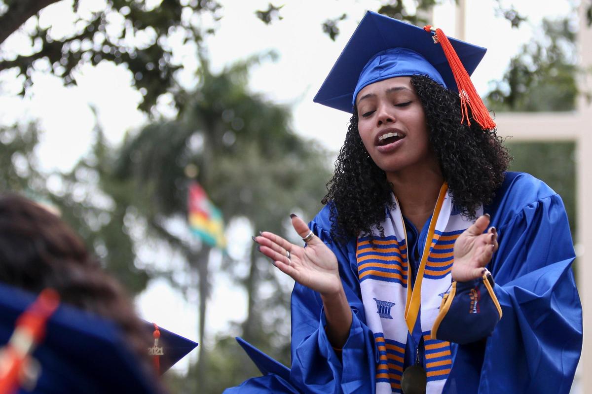 A student reacts during commencement for students graduating as part of the class of 2020 and 2021 at Florida Memorial University in Miami Gardens on Saturday, May 8, 2021.