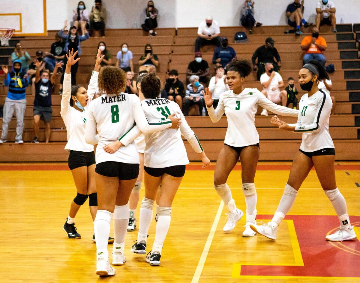 The Hialeah Gardens Mater Academy Charter Lions react after scoring against the Fort Myers Green Wave during the FHSAA Class 6A girls’ volleyball state semifinal match at Monsignor Edward Pace High School gym, in Miami Gardens, Florida, on Saturday, November 7, 2020. The Hialeah Gardens Mater Academy Charter Lions defeated Fort Myers Green Wave 3-2.