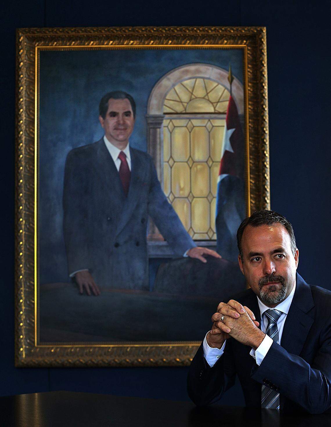MasTec CEO José Mas in front of a portrait of his father in the conference room at the company’s Coral Gables office.