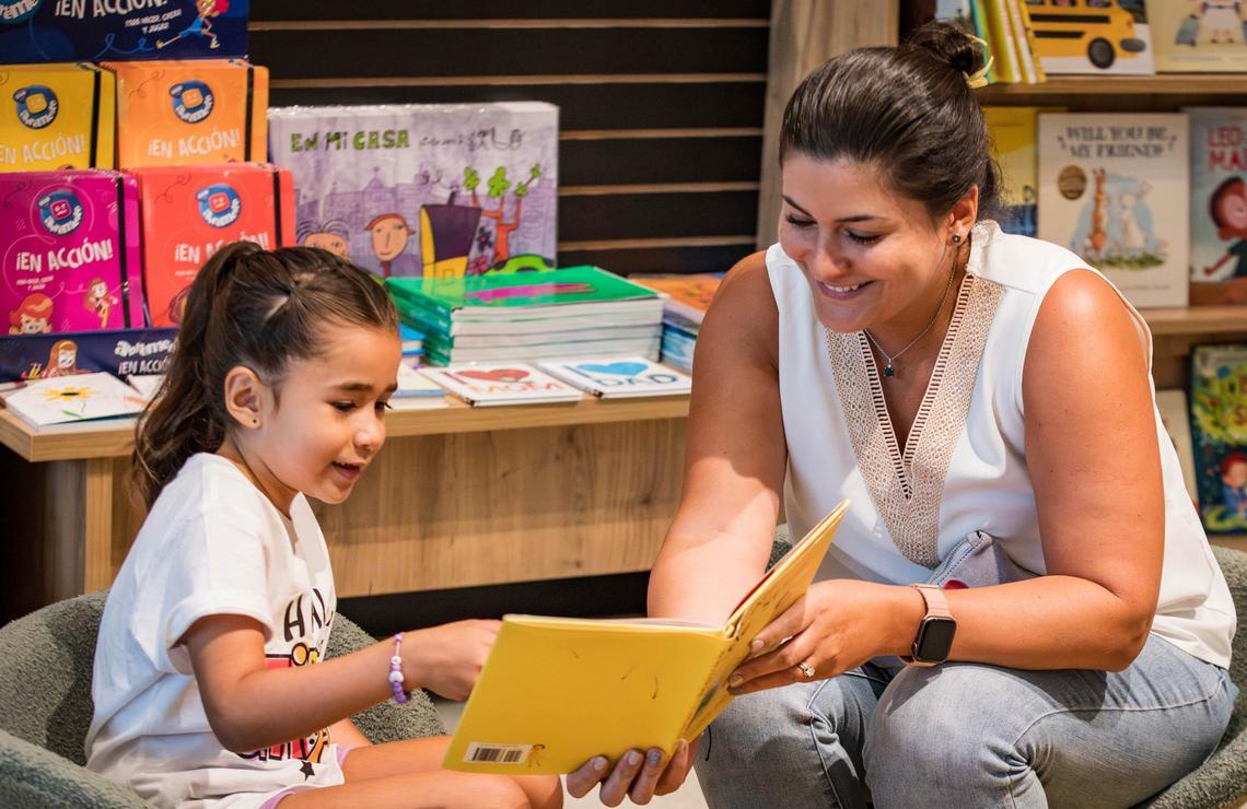 Farah Cano, right, reads the book ‘You are a Little Seed’ to her daughter Valentina Cicardini at Quade Books in Aventura Mall on Friday, August 9, 2024 in Aventura, Fla.