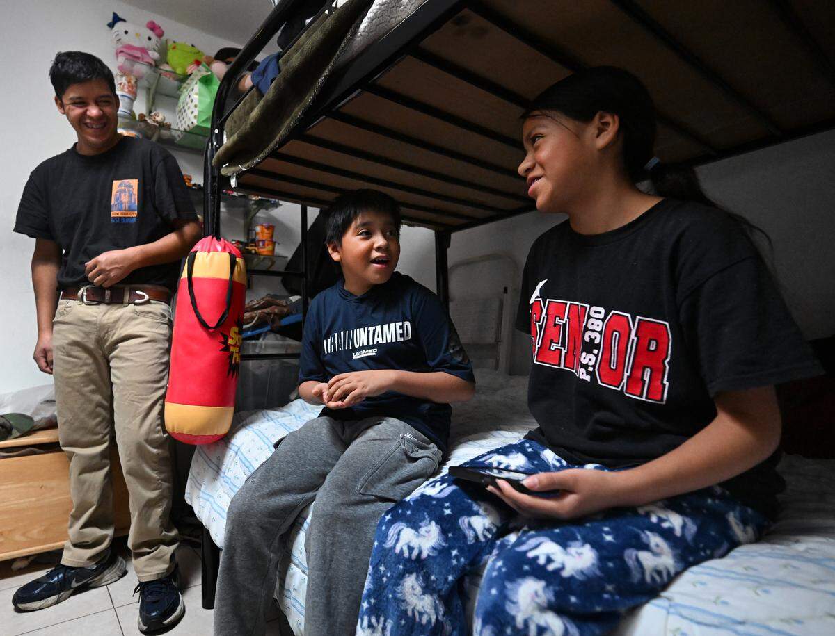 Ruben and his children Christopher and Rosa after his release from ICE detention at their apartment in Brooklyn on Dec. 21, 2025. 