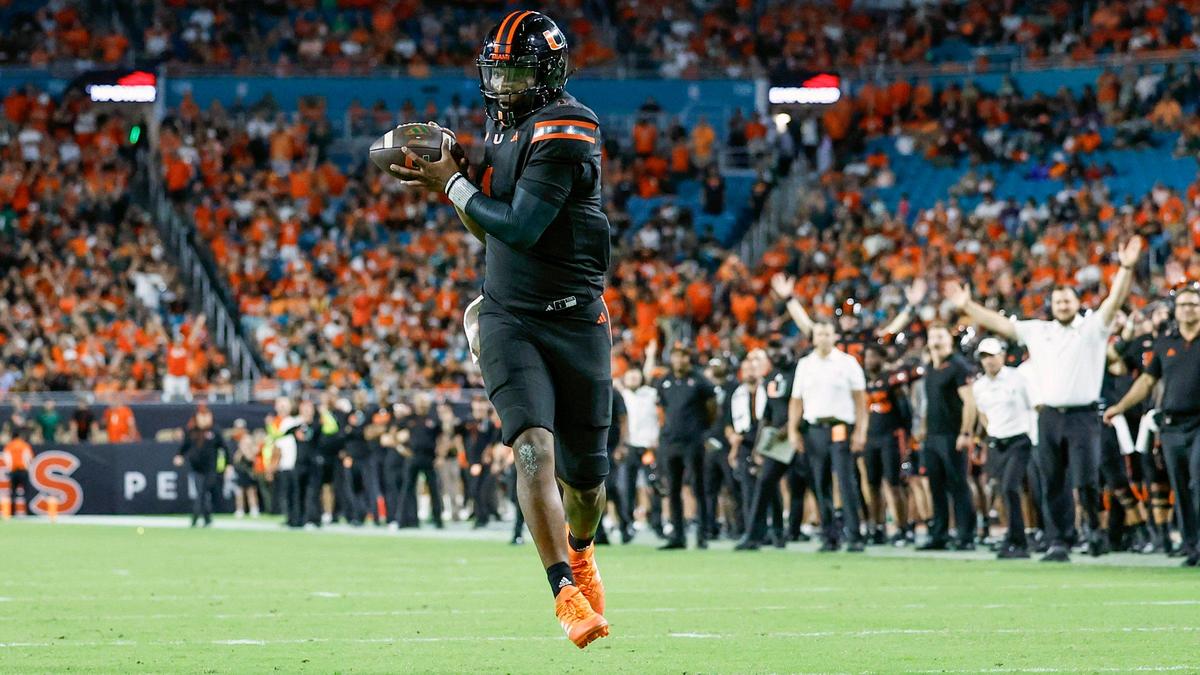 Miami Hurricanes quarterback Cam Ward (1) scores on a pass by tight end Elija Lofton (9) against the Florida State Seminoles in the second half during an NCAA football game at Hard Rock Stadium in Miami Garden, Florida on Saturday, October 26, 2024.