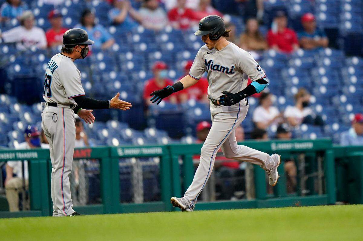 Miami Marlins’ Brian Anderson, right, celebrates with third base coach Trey Hillman after hitting a home run off Philadelphia Phillies pitcher Zach Eflin during the second inning of a baseball game, Wednesday, May 19, 2021, in Philadelphia.