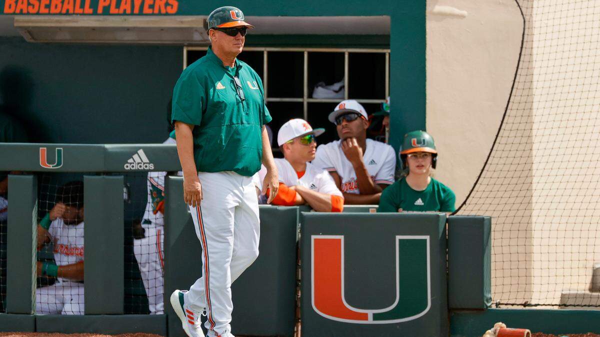 Miami Hurricanes head coach Gino DiMare looks on during the first inning of an NCAA baseball game against the Towson Tigers in Alex Rodriguez Park at Mark Light Field on Sunday, February 20, 2022 in Coral Gables.