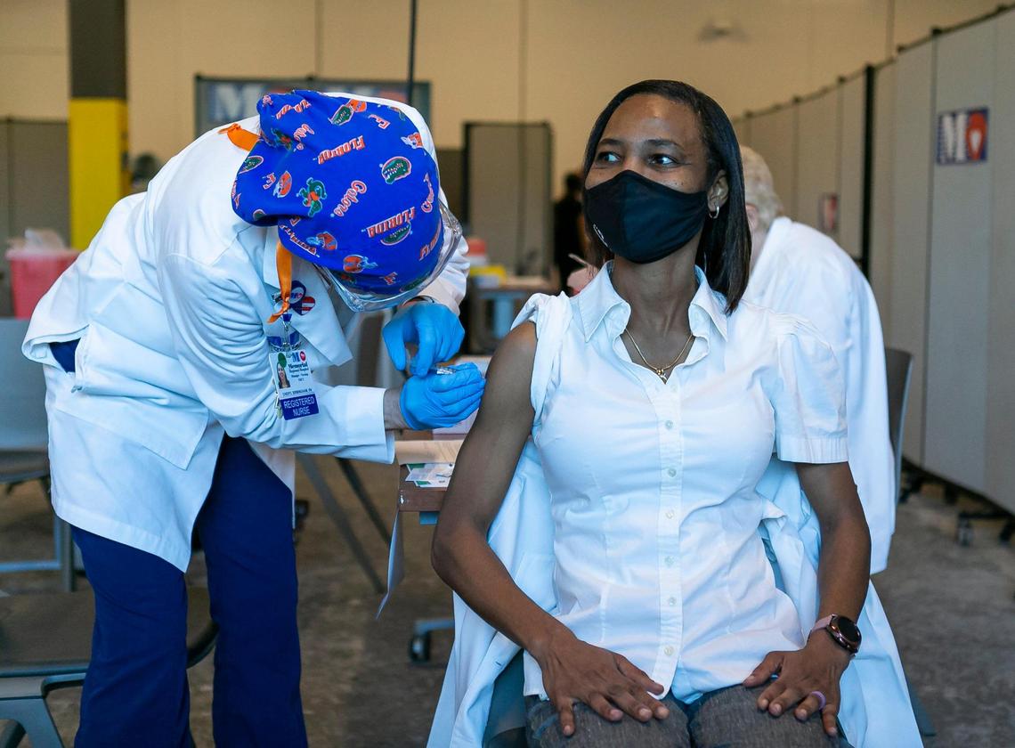 Nurse La Tanya Forbes receives the third dose of the Pfizer BioNTech Vaccine at Memorial Specialty Pharmacy in Miramar, Florida on Monday, December 14, 2020.