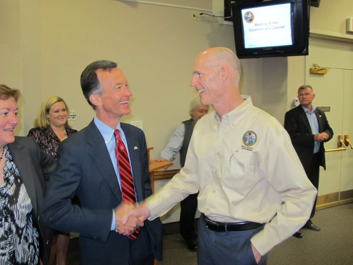 Gov. Rick Scott (R) greets Tom Grady (L) during a 2012 Cabinet meeting in which Grady was appointed head of Financial Regulation.