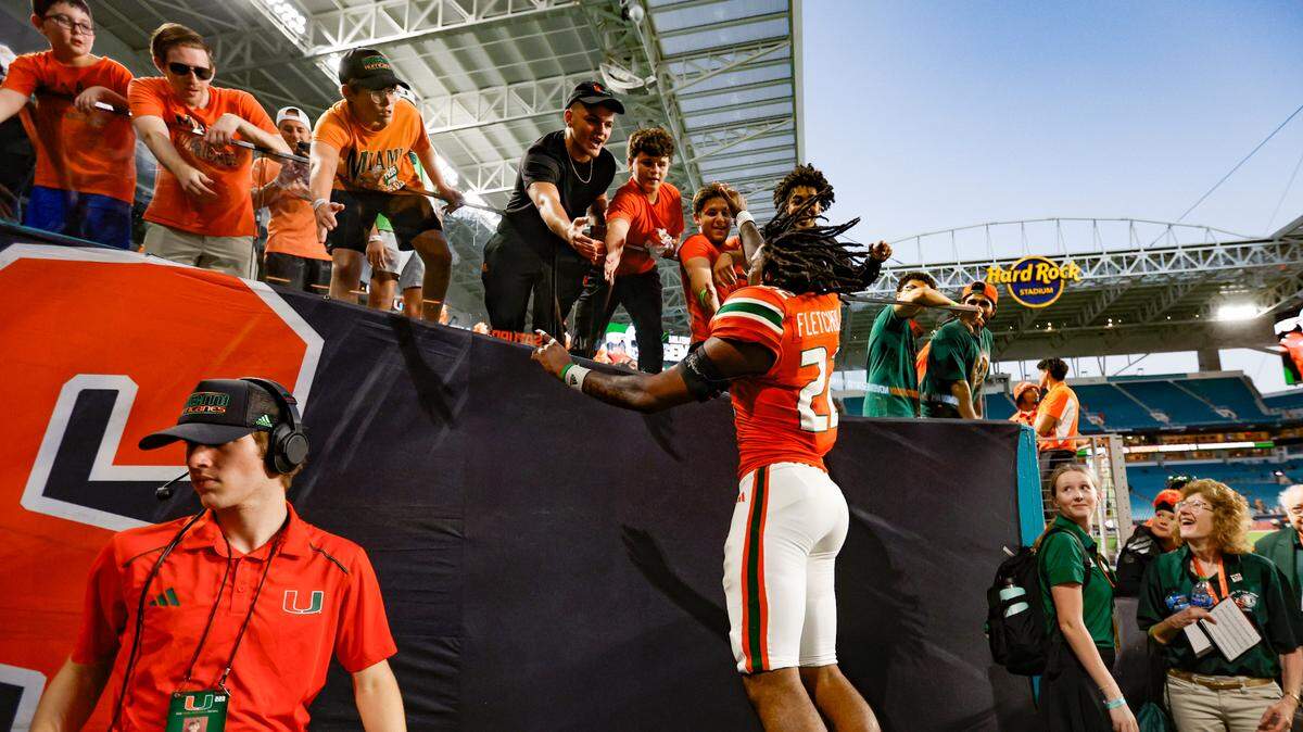 Miami Hurricanes running back Mark Fletcher Jr. (22) celebrates with fans after the game. Fletcher scored in overtime to defeat the Virginia Cavaliers at Hard Rock Stadium in Miami Gardens on Saturday, October 28, 2023.