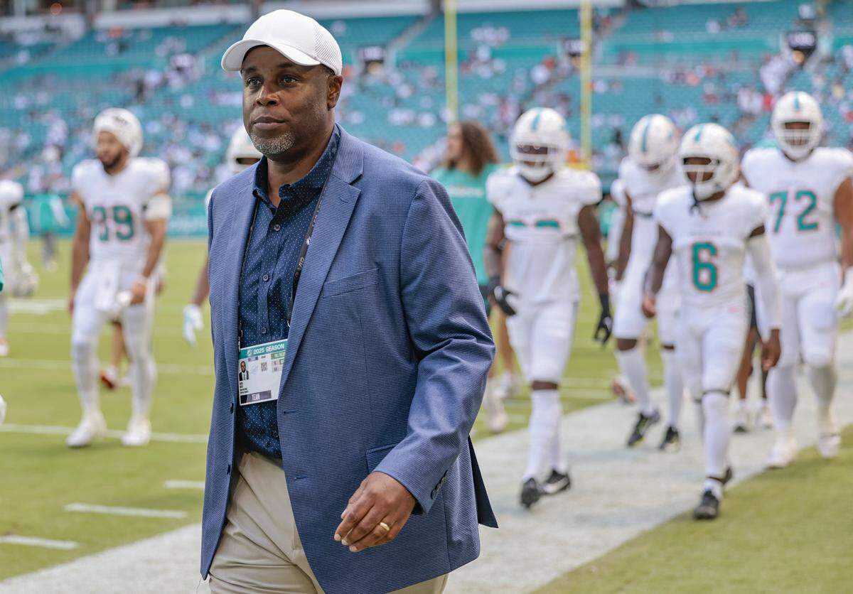 Chris Grier, general manager of the Miami Dolphins, walks off the field before the start of NFL football game against the New England Patriots at Hard Rock Stadium in Miami Gardens, Florida, on Sunday, September 14, 2025.