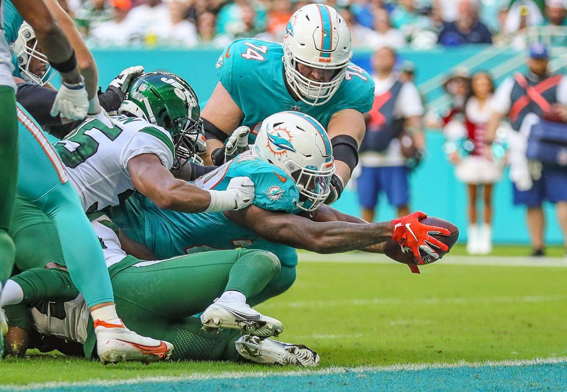 Miami Dolphins running back Duke Johnson (28) reaches for the goal line to score in the third quarter against the New York Jets at Hard Rock Stadium in Miami Gardens on Sunday, December 19, 2021.