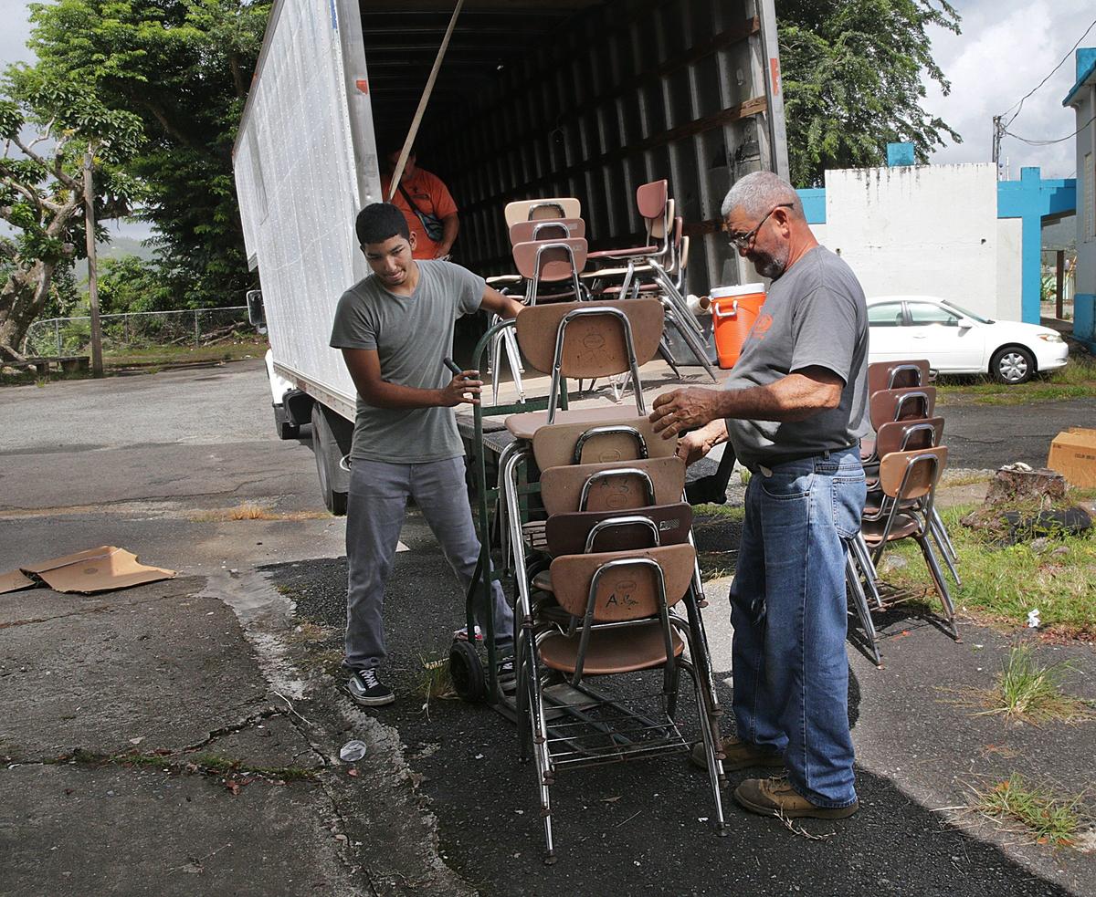 Workers remove furniture and materials from Marcos Sánchez K-8 Center after the school was closed.