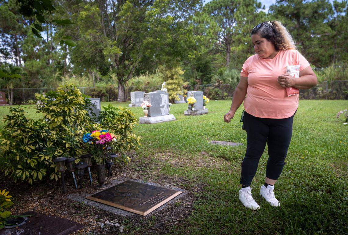 Gamaly Hollis looks back to her son’s grave after she cleaning it during a visit early this year. Richard Hollis was shot by Miami-Dade police officer Jaime Pino in June 2022. His mother was jailed for a year for violating a protective order granted to Pino.