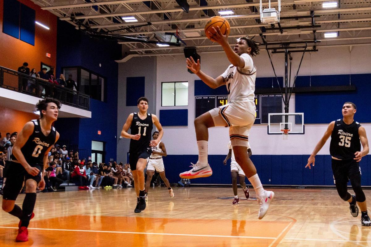 Mater Lakes guard Michael Bradley III (0) drives through the lane after cutting past Riviera Prep defenders during a high school basketball game at Mater Lakes High School in Hialeah, Florida, on Wednesday, January 18, 2023.