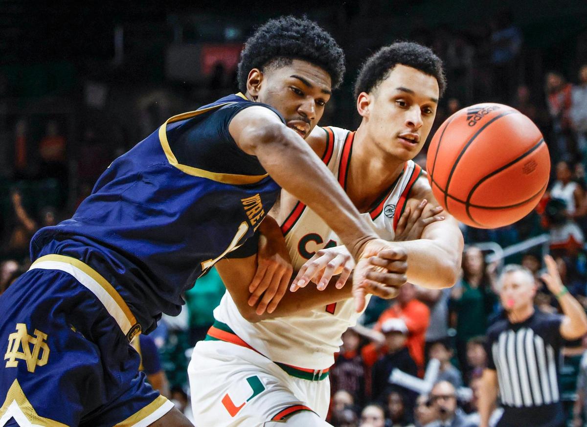 Miami Hurricanes center Lynn Kidd (1) and Notre Dame Fighting Irish forward Kebba Njie (14) battle under the basket in the first half of their ACC basketball game at the Watsco Center in Coral Gables, Florida on Saturday, February 1, 2025.