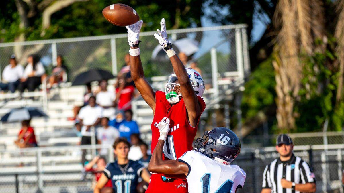 Chaminade-Madonna College Preparator wide receiver Edwin Joseph (4) makes the catch for the touchdown over Miami Palmetto cornerback Lawrence Johnson (14) during the football preseason exhibition at Cardinal Gibbons High School in Fort Lauderdale, Florida, on Thursday, August 18, 2022