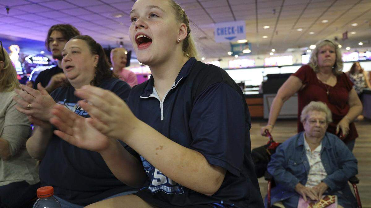 Coral Springs Charter School eighth-grader Katarina Hagler, 13, cheers on teammates during a bowling match. Hagler set county and state records for bowling average as she competes at Sawgrass Lanes in Tamarac, Florida on Thursday, October 17, 2019.