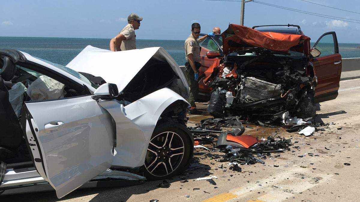 Officers with the Florida Fish and Wildlife Conservation Commission help at the scene of a head-on collision on the Seven Mile Bridge Monday, July 23, 2018.