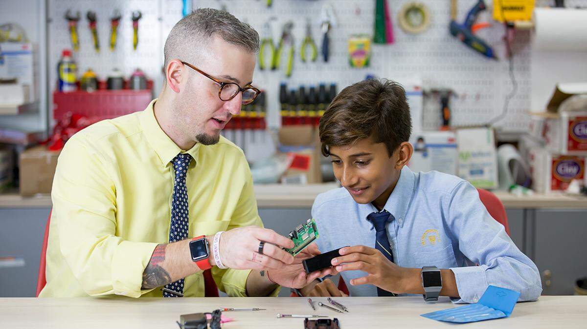 Palmer Trinity School’s innovation coordinator Brian Diaz, left, sits with student Akshay Panjabi in one of three innovation spaces that were created to promote the development of creativity, problem-solving and interdisciplinary skills in students.