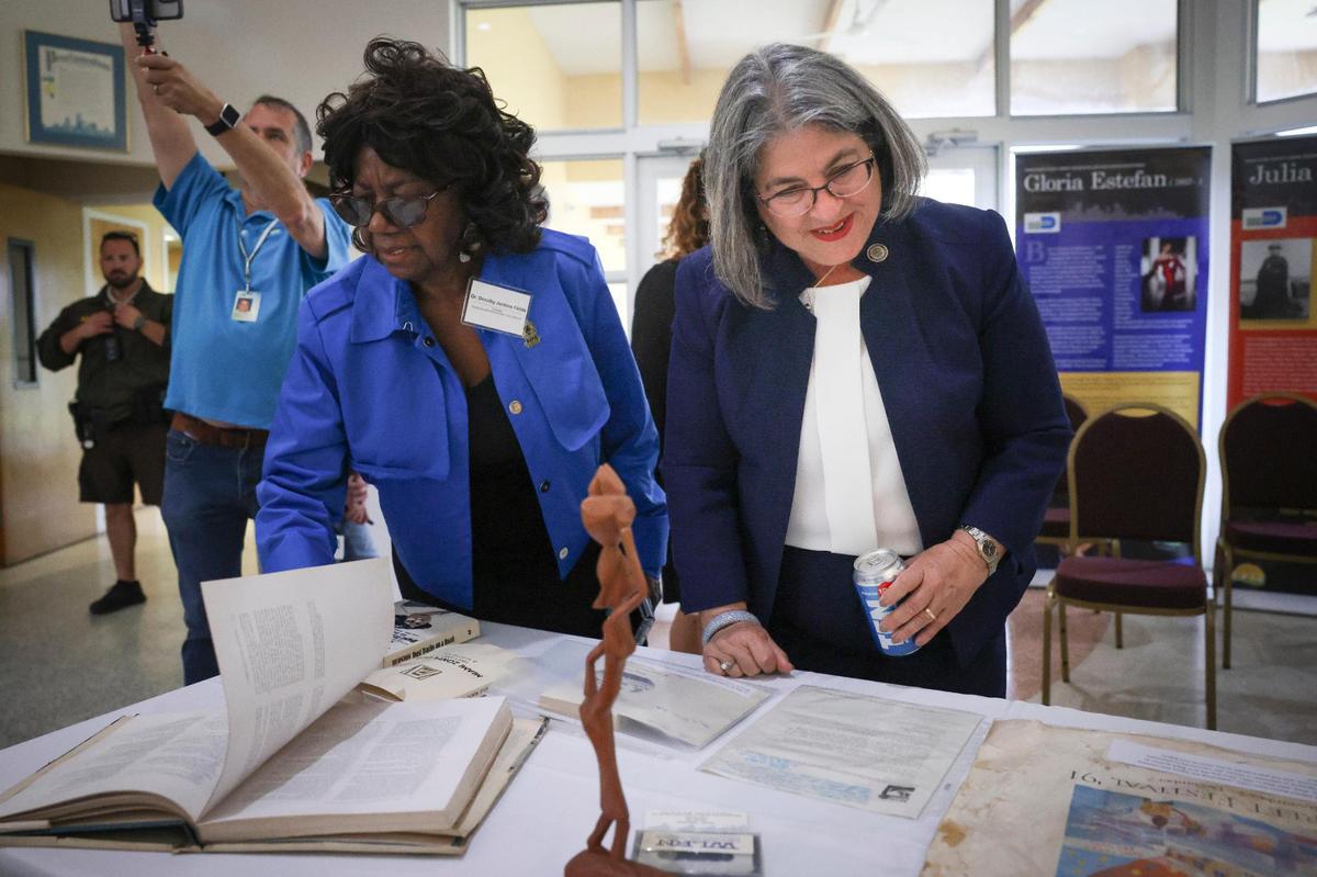 Mayor Daniella Levine Cava, right, looks at the unveiled contents of a time capsule that was buried 31 years ago with Dr. Dorothy Jenkins Fields on Wednesday, March 22, 2023, at The Women’s Park in Miami.