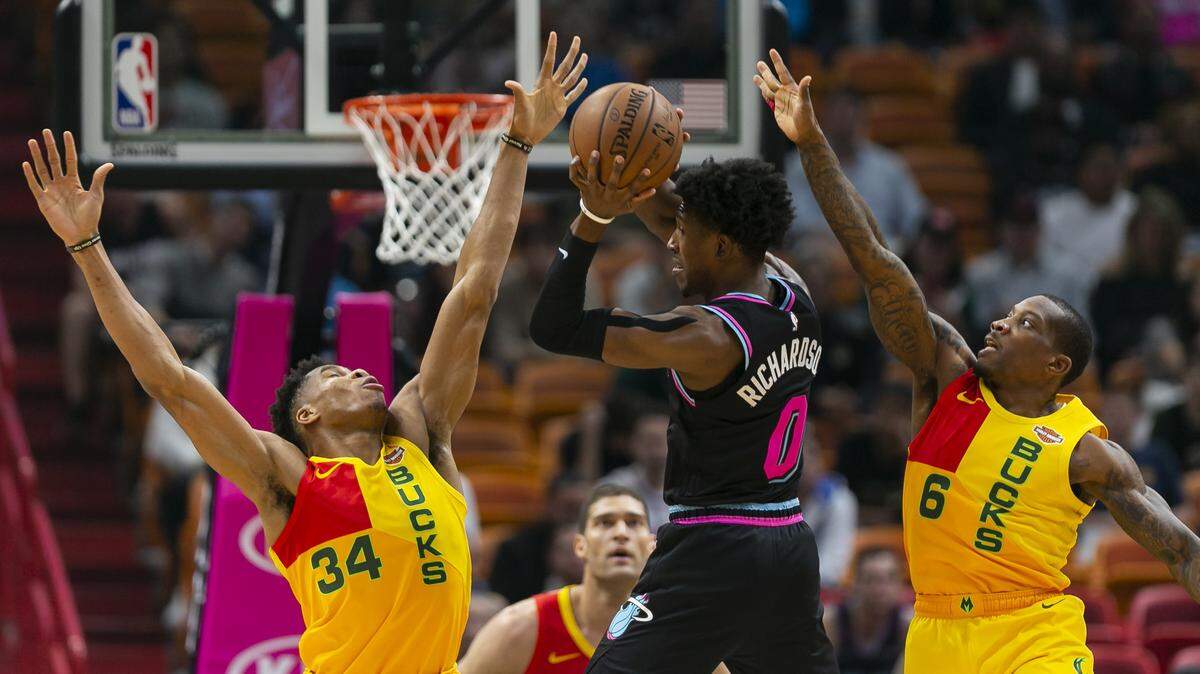 Miami Heat guard Josh Richardson (0) passes the ball against Milwaukee Bucks forward Giannis Antetokounmpo (34) in the first quarter as the Heat host the Milwaukee Bucks at the AmericanAirlines Arena on Saturday, Dec. 22, 2018.