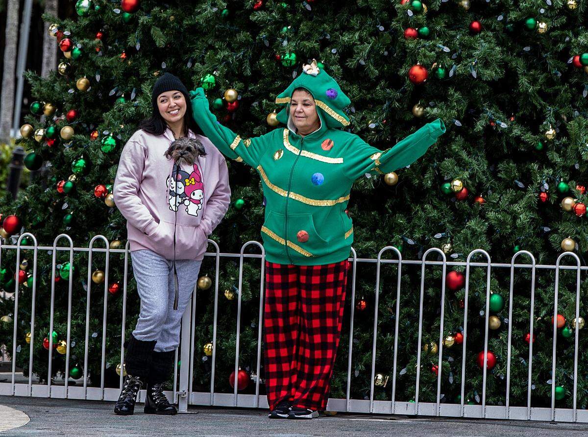 The cold temperatures in Miami on Christmas Day didn’t stop Jennifer Hierro (left) and Mercedes Hierro to take a walk along Calle 8 in Little Havana, as the cold temperatures affecting Florida continues through the holiday weekend, on Sunday December 25, 2022.