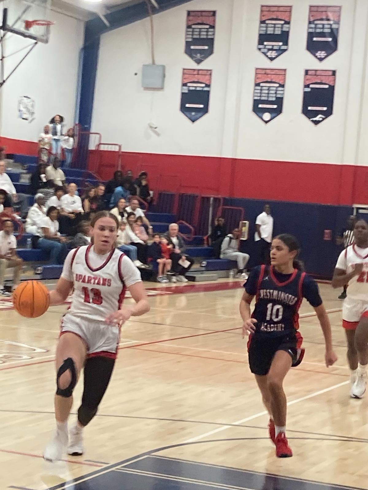 Miami Country Day’s Jalynn Belton, who led all scorers in the game with 16 points, drives past Westminster’s Catalina LaFreniere for a second quarter basket in Friday’s Region 4-2A girls’ basketball final at Miami Country Day School.