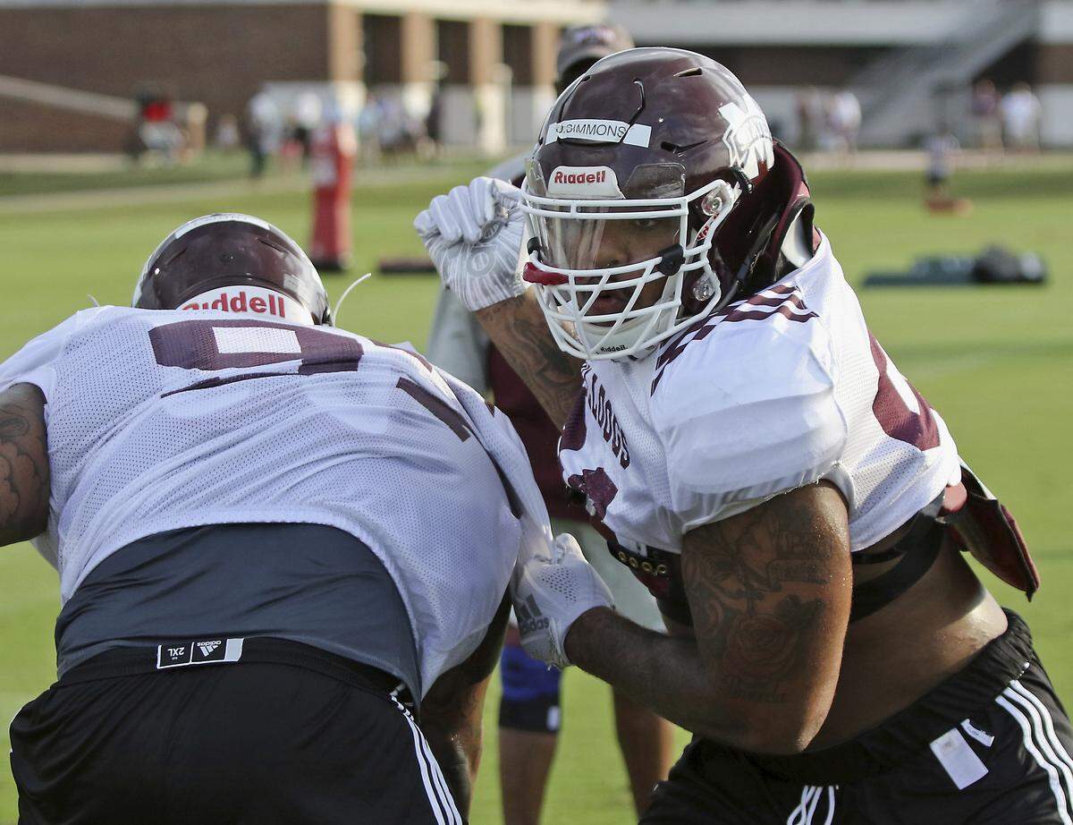 In this Aug. 10, 2018, photo, Mississippi State defensive lineman Jeffery Simmons, right practices a blocking drill with fellow lineman Lee Autry, left as they prepare for the upcoming 2018 NCAA college football season in Starkville, Miss.The Bulldogs are betting on the leadership of returning starters like Simmons to help lead the team under first-year coach Joe Moorhead. (AP Photo/Jim Lytle)