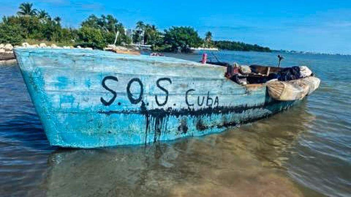 A rustic vessel with ‘SOS Cuba’ written on the side rests in the shallow water off Marathon in the Florida Keys Tuesday, Jan. 4, 2022.