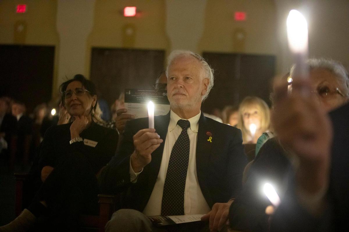 Drew Tabone holds a candle as Miami’s Jewish community gathers at Temple Israel of Greater Miami on November 10, 2024, to commemorate Kristallnacht, the Night of Broken Glass.